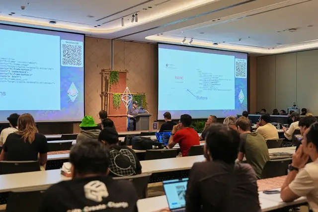 A presenter and workshop participants with laptops at Devcon SEA.